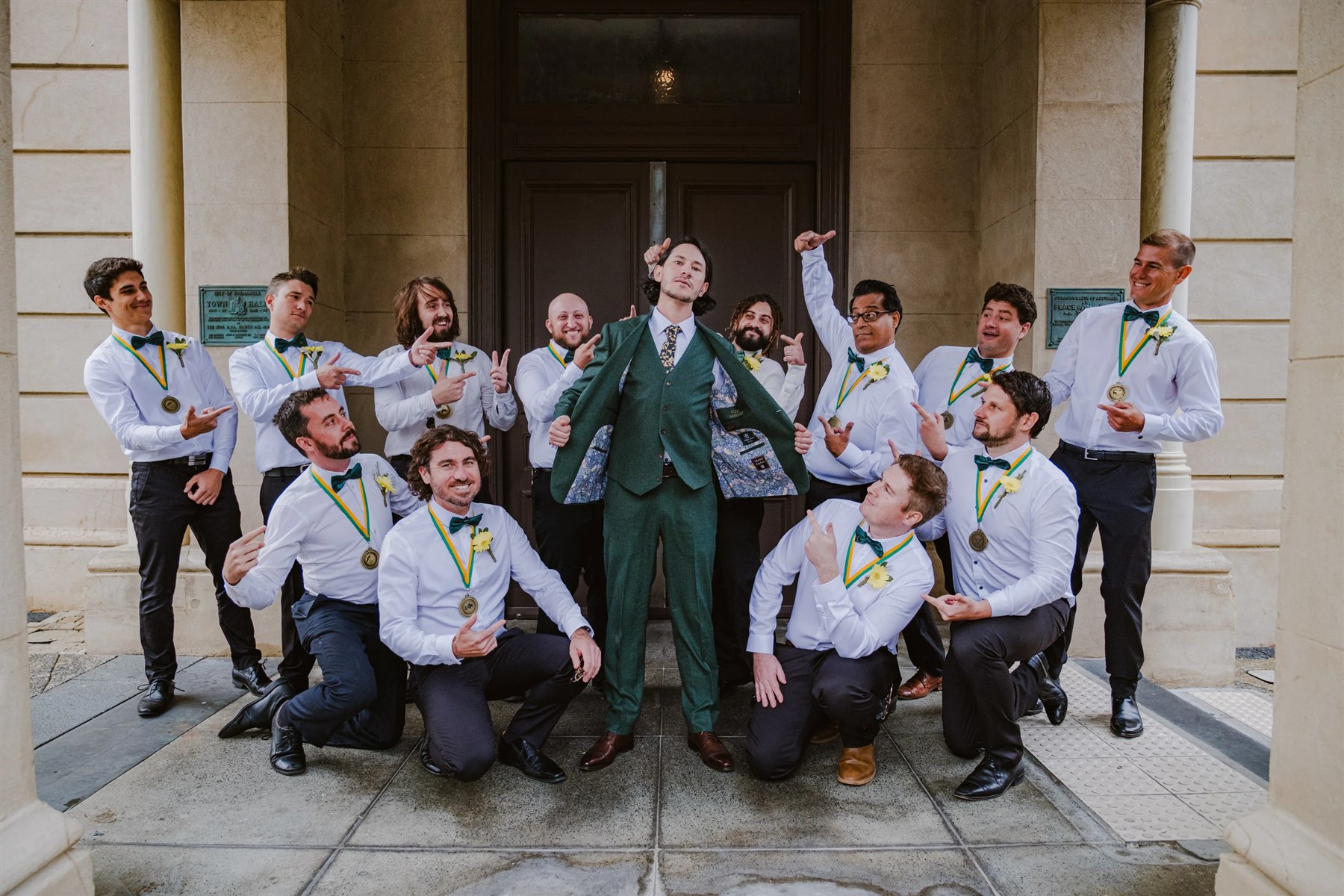 Perfect Attire | Wedding Suits & Tuxedos Singapore Groom in a green three-piece suit surrounded by his groomsmen