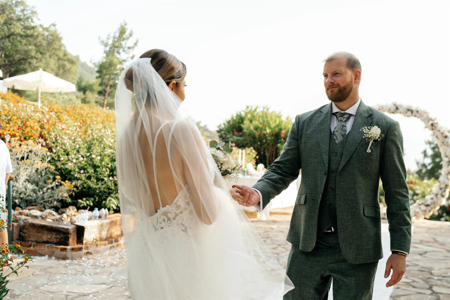 Perfect Attire | Wedding Suits & Tuxedos Singapore Groom in a green three-piece suit at an outdoor wedding